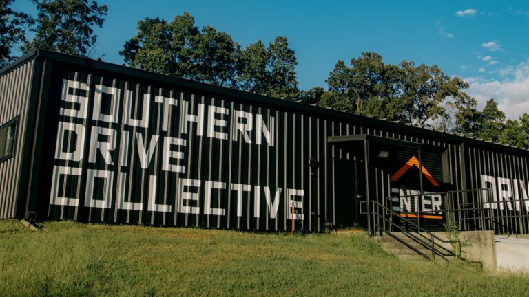 The Southern Drive Collective building from outside, with the ENTER doorway at the top of the steps