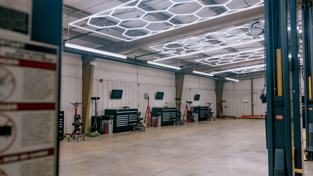 The open shop floor, with workstations along the back wall under hexagon lights